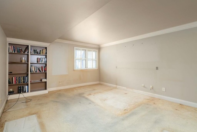 spare room with carpet floors, baseboards, and ornamental molding