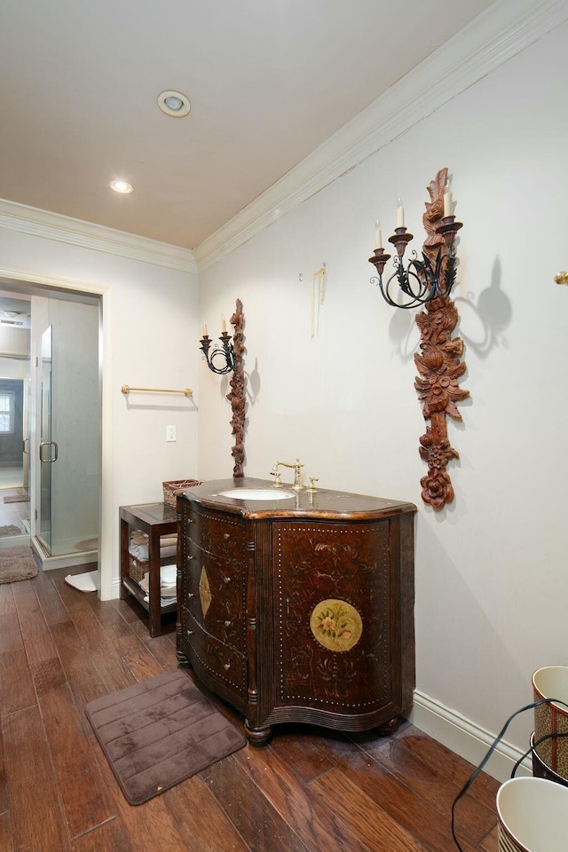 hall featuring baseboards, dark wood-style flooring, crown molding, a sink, and recessed lighting