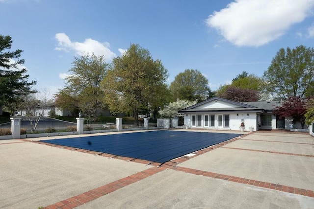 pool featuring a patio and fence