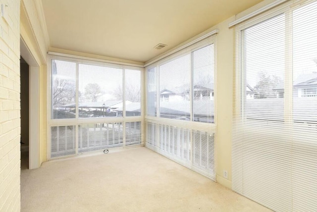 unfurnished sunroom with visible vents