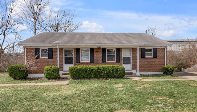 single story home featuring entry steps, a front lawn, and brick siding