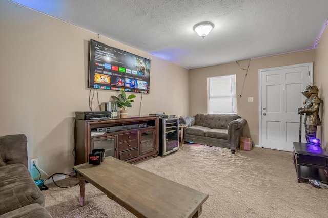 living room with carpet floors, baseboards, and a textured ceiling