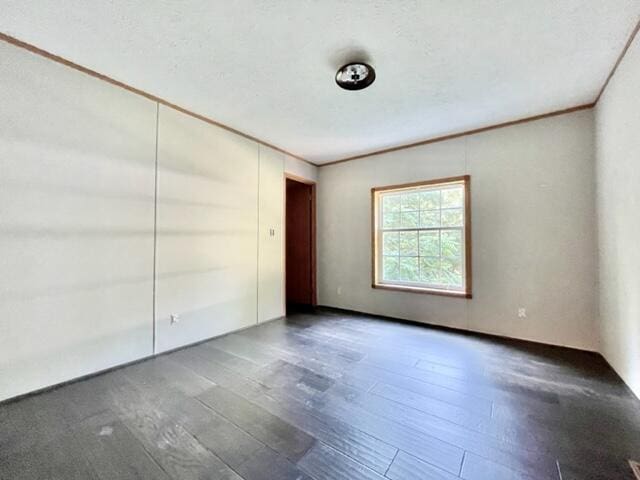 unfurnished room with hardwood / wood-style flooring and ornamental molding