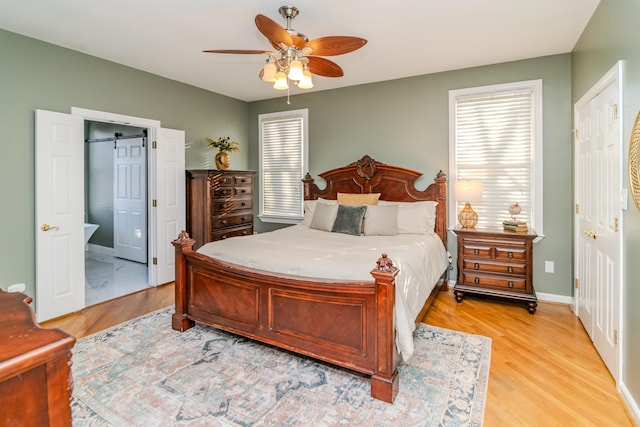 bedroom with baseboards, multiple windows, light wood-style flooring, and a ceiling fan