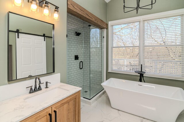 bathroom with a stall shower, vanity, marble finish floor, and a soaking tub