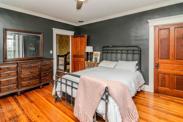 bedroom with ceiling fan, ornamental molding, and wood finished floors