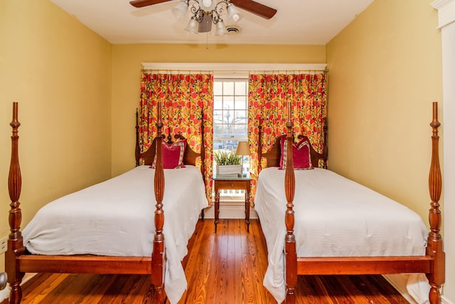 bedroom featuring wood-type flooring and a ceiling fan