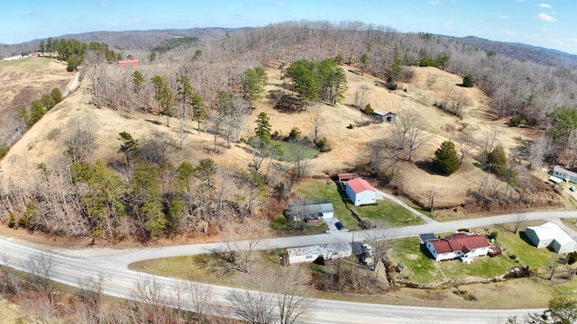 drone / aerial view with a wooded view