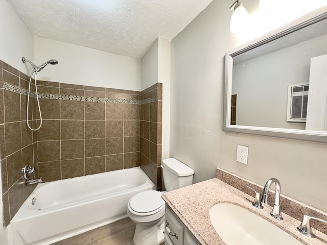 full bathroom with shower / bath combination, toilet, a textured ceiling, vanity, and wood finished floors