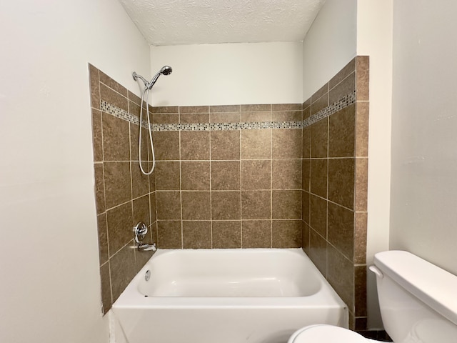 bathroom featuring toilet, a textured ceiling, and shower / bathtub combination