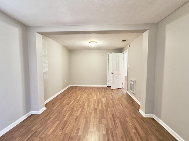 empty room featuring baseboards and wood finished floors