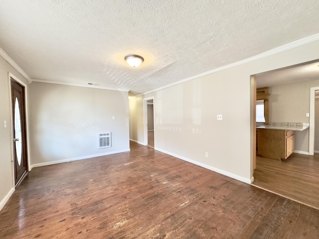 unfurnished room with dark wood-type flooring, visible vents, and ornamental molding