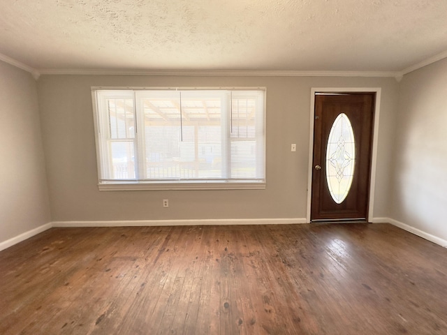 entrance foyer with dark wood-type flooring, ornamental molding, and baseboards