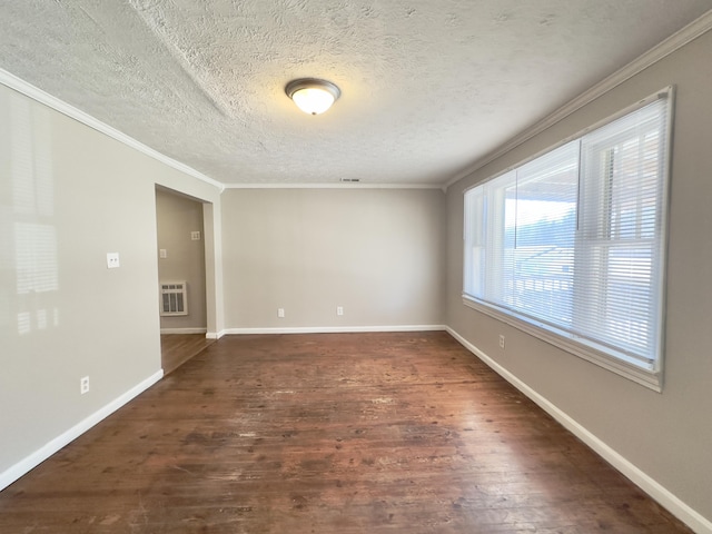 unfurnished room featuring a textured ceiling, ornamental molding, dark wood finished floors, and baseboards