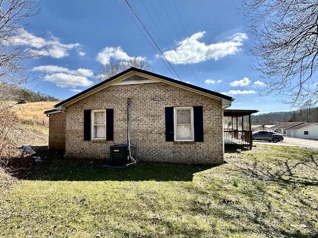 view of home's exterior featuring a yard, brick siding, and central AC