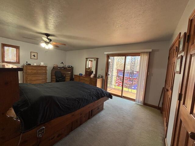 bedroom with light carpet, baseboards, ceiling fan, access to exterior, and a textured ceiling