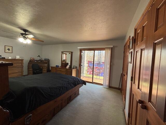 bedroom with light carpet, access to outside, baseboards, and a textured ceiling