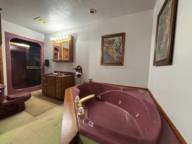 bathroom featuring a textured ceiling, visible vents, vanity, a whirlpool tub, and an enclosed shower