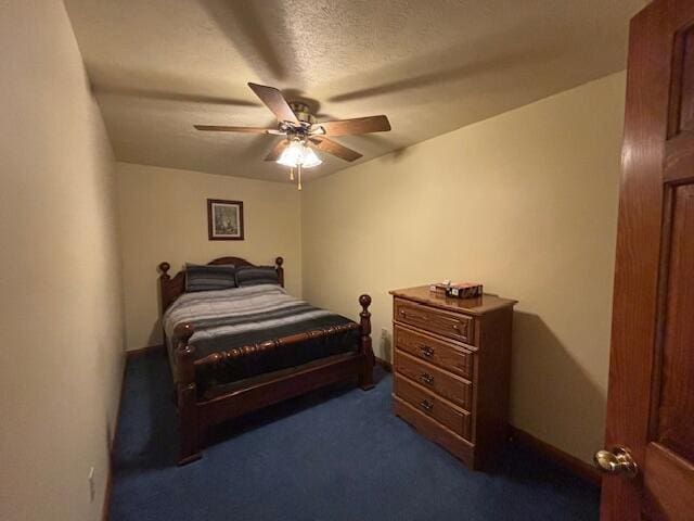 bedroom with carpet floors, ceiling fan, and a textured ceiling