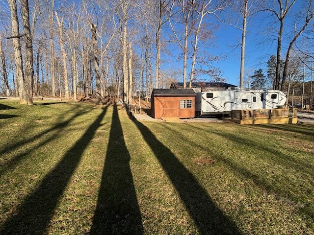 view of yard featuring an outbuilding and a storage shed