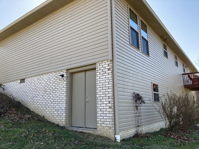 view of property exterior featuring brick siding