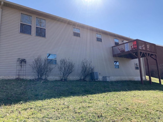 view of property exterior featuring a yard, cooling unit, and a wooden deck