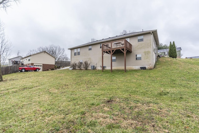 rear view of property featuring a yard, central AC, and fence