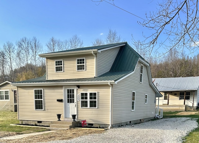 view of front of property featuring crawl space and metal roof