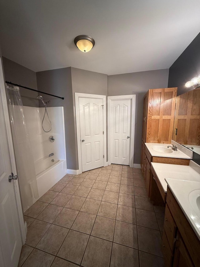 bathroom featuring shower / bath combo with shower curtain, tile patterned flooring, vanity, and baseboards