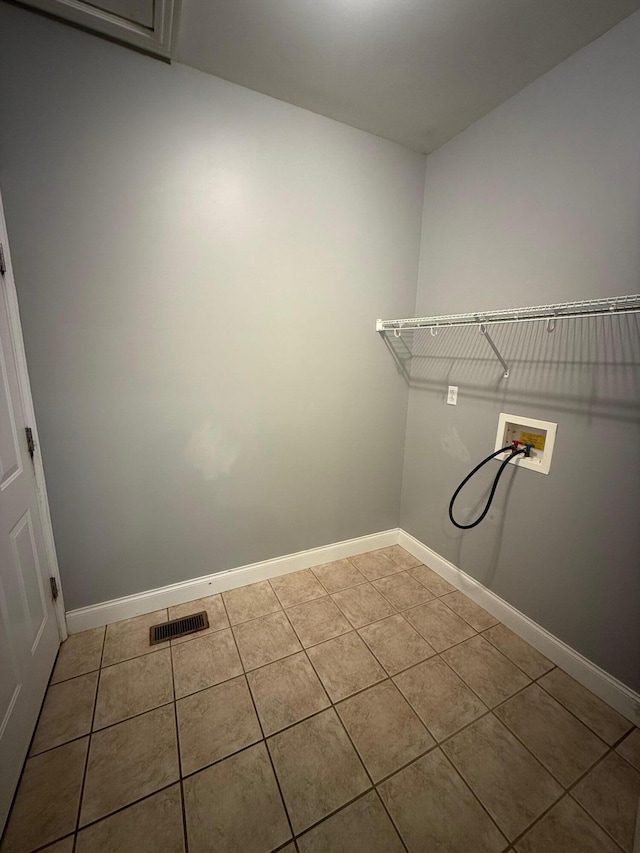 clothes washing area featuring hookup for a washing machine, visible vents, laundry area, baseboards, and tile patterned floors