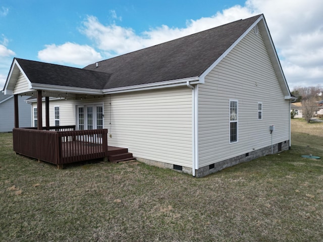 rear view of house featuring a shingled roof, crawl space, a wooden deck, and a lawn