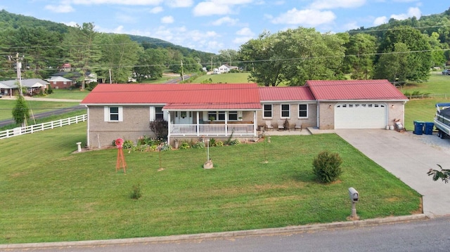 ranch-style house with an attached garage, brick siding, driveway, and a front lawn