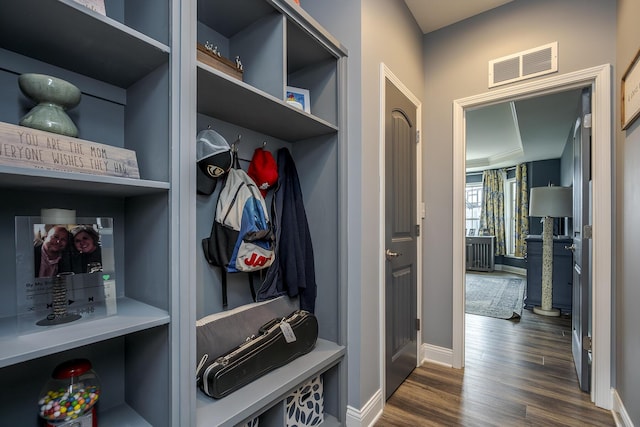 mudroom featuring visible vents, dark wood finished floors, and baseboards