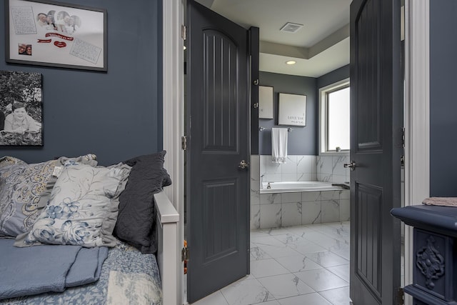 full bathroom with marble finish floor, visible vents, and a garden tub