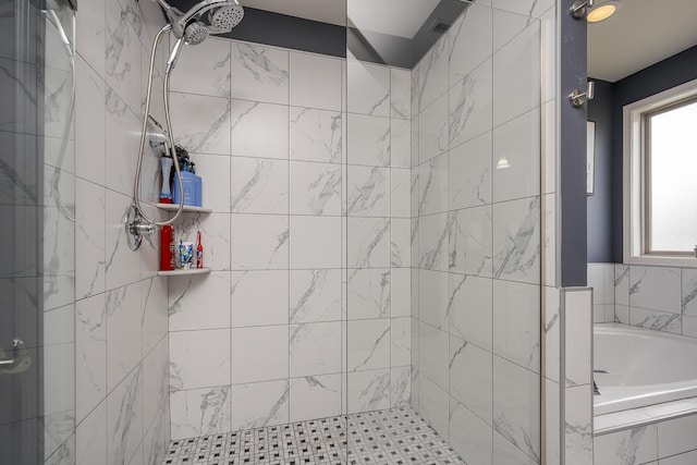 bathroom featuring a shower stall and a bath