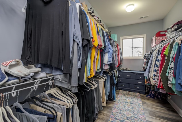 walk in closet featuring visible vents and wood finished floors