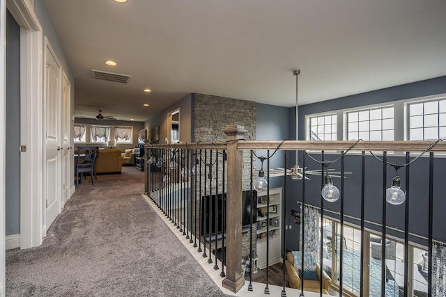 hallway with carpet floors, plenty of natural light, visible vents, and recessed lighting