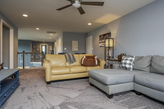 carpeted living area with ceiling fan, visible vents, and recessed lighting