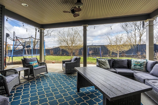 view of patio / terrace featuring a trampoline, a fenced backyard, an outdoor hangout area, and a ceiling fan