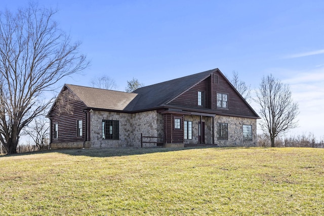 view of front of house with stone siding and a front lawn