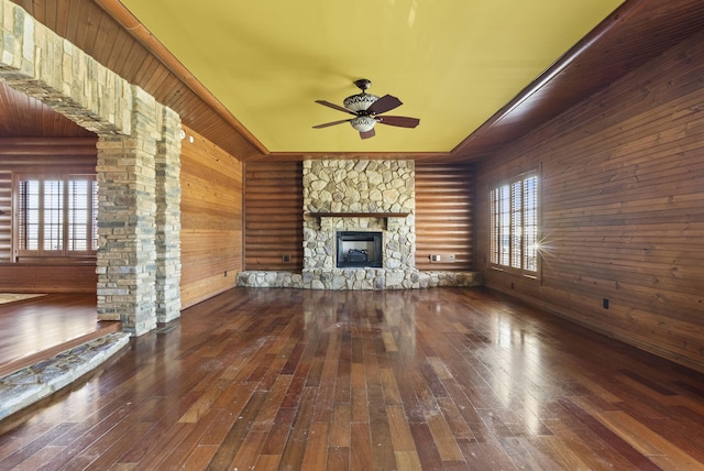 unfurnished living room featuring plenty of natural light, a fireplace, and hardwood / wood-style flooring