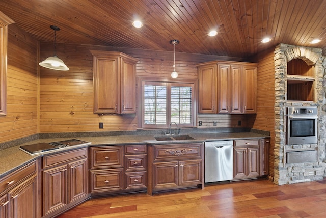 kitchen with dark countertops, wooden ceiling, appliances with stainless steel finishes, and a sink