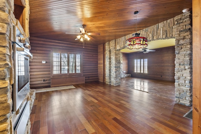 unfurnished living room with wood ceiling, plenty of natural light, ceiling fan, and wood finished floors