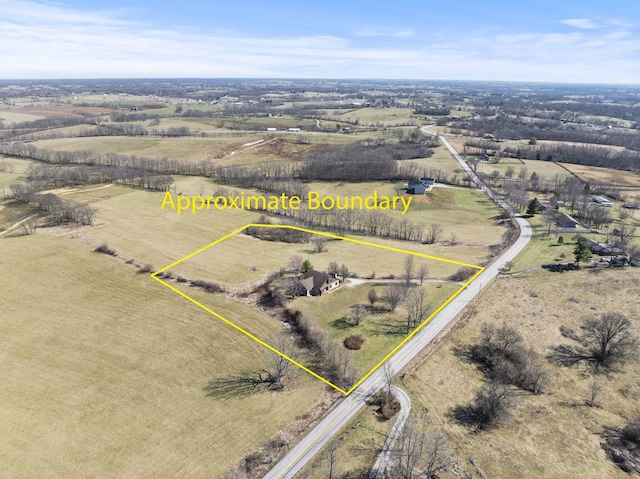 birds eye view of property featuring a rural view