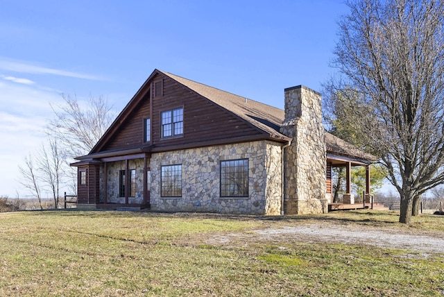 view of side of home with a lawn and a chimney