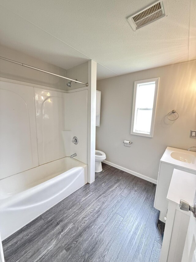 71 Pike St, Brodhead, KY 40409 - bathroom featuring toilet, wood finished floors, vanity, baseboards, and shower / tub combination