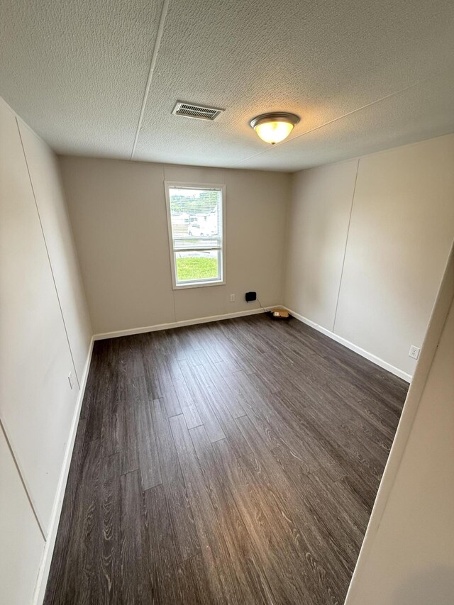 71 Pike St, Brodhead, KY 40409 - empty room featuring dark wood-style flooring, baseboards, and a textured ceiling