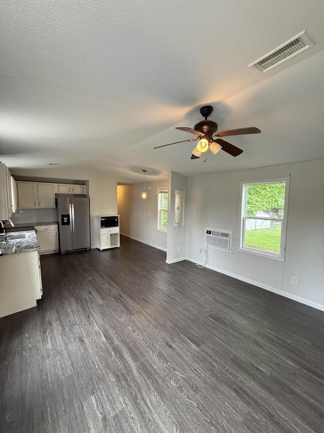 71 Pike St, Brodhead, KY 40409 - unfurnished living room with a ceiling fan, dark wood-type flooring, healthy amount of natural light, and a textured ceiling