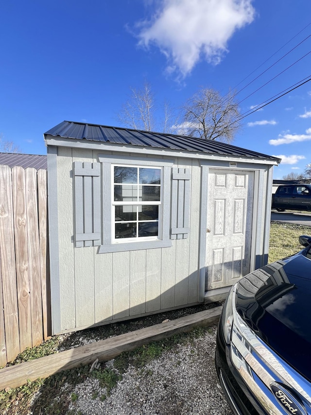 view of shed with fence