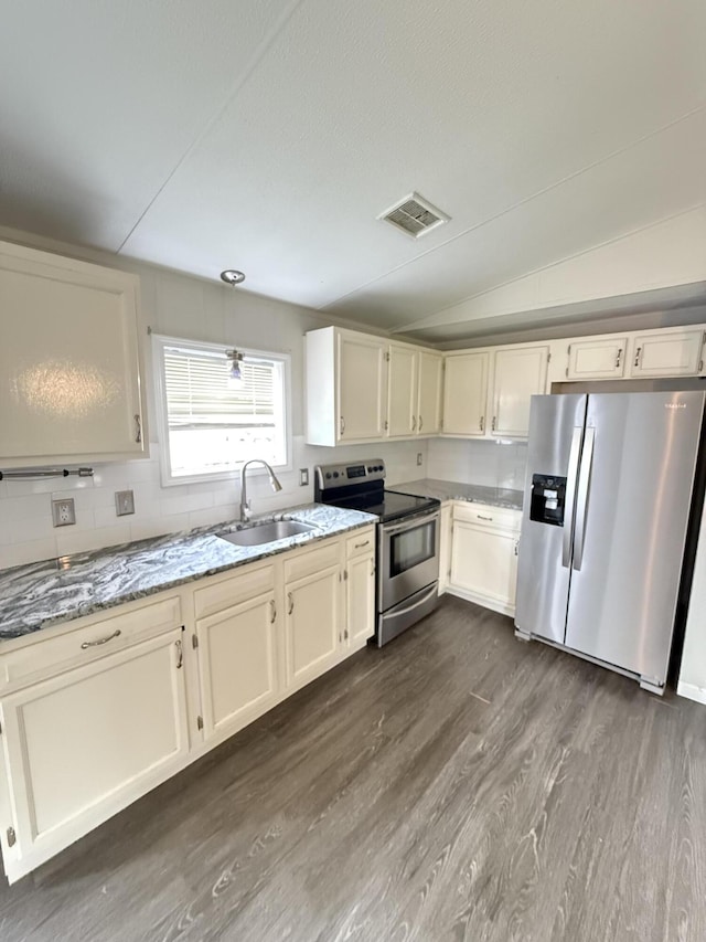 71 Pike St, Brodhead, KY 40409 - kitchen with stainless steel appliances, a sink, dark wood-style flooring, light stone counters, and vaulted ceiling